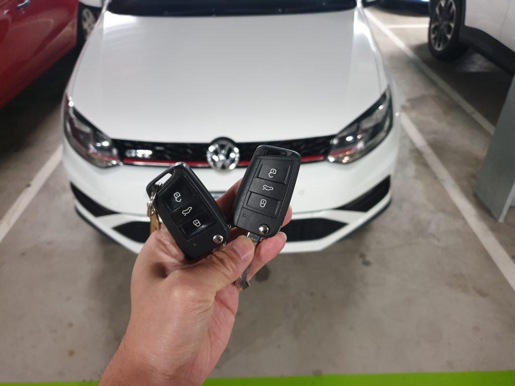 Technician testing newly programmed car keys for proper function