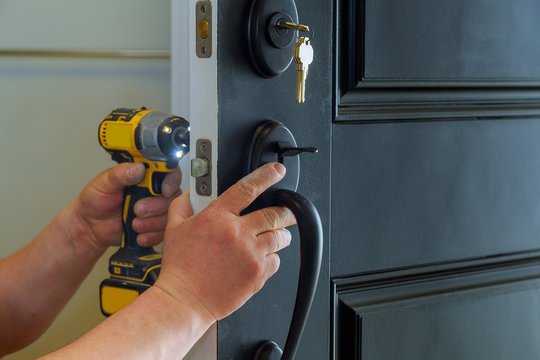 Locksmith technician repairing a home door lock in Greenburgh NY