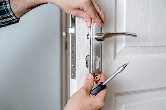 Locksmith installing a deadbolt on a home in Yorktown NY