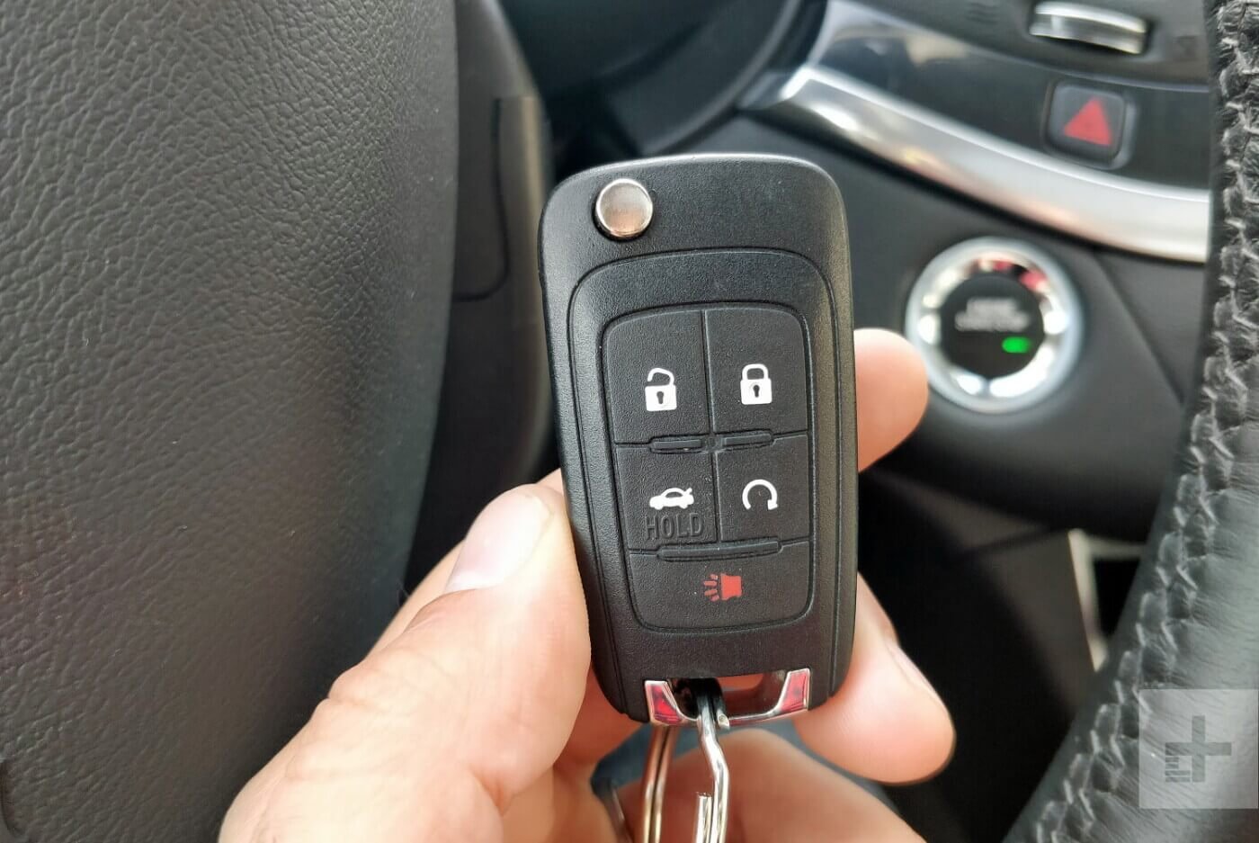 Car Key Fob Replacement and Programming Guide hand holding car key