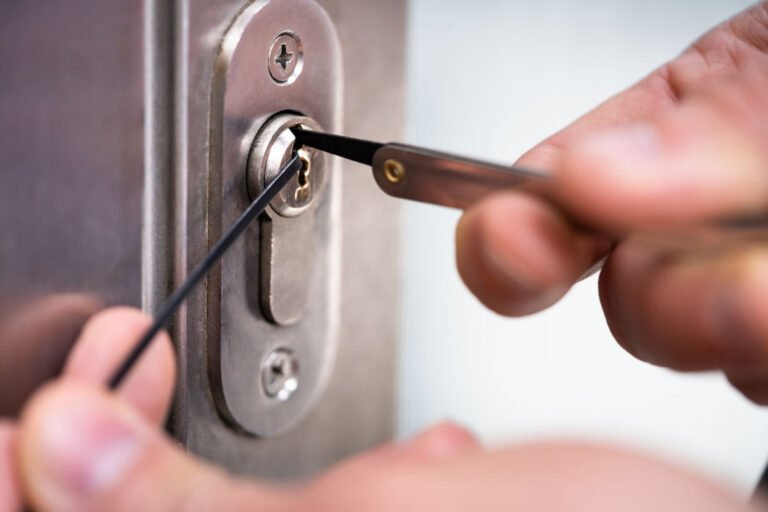 Locksmith installing a new deadbolt lock on a front door of a home