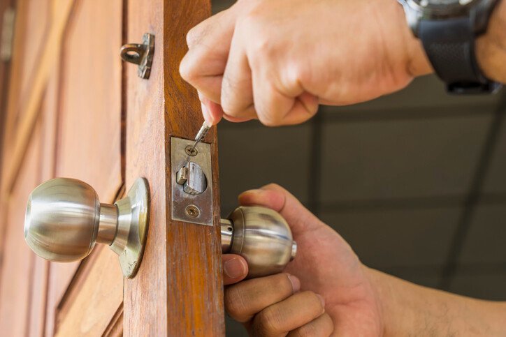 Locksmith repairing a front door lock at a home in Piermont NY