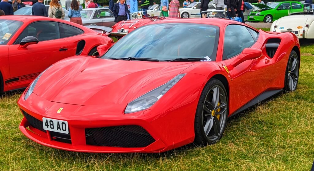Ferrari sports car parked outdoors showcasing sleek red exterior design.
