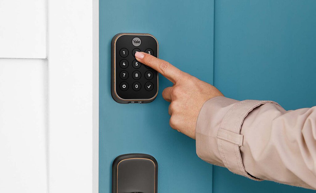 Modern smart lock installed on a front door with keypad and mobile app control