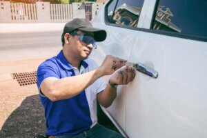 a man wearing blue unlocking the car