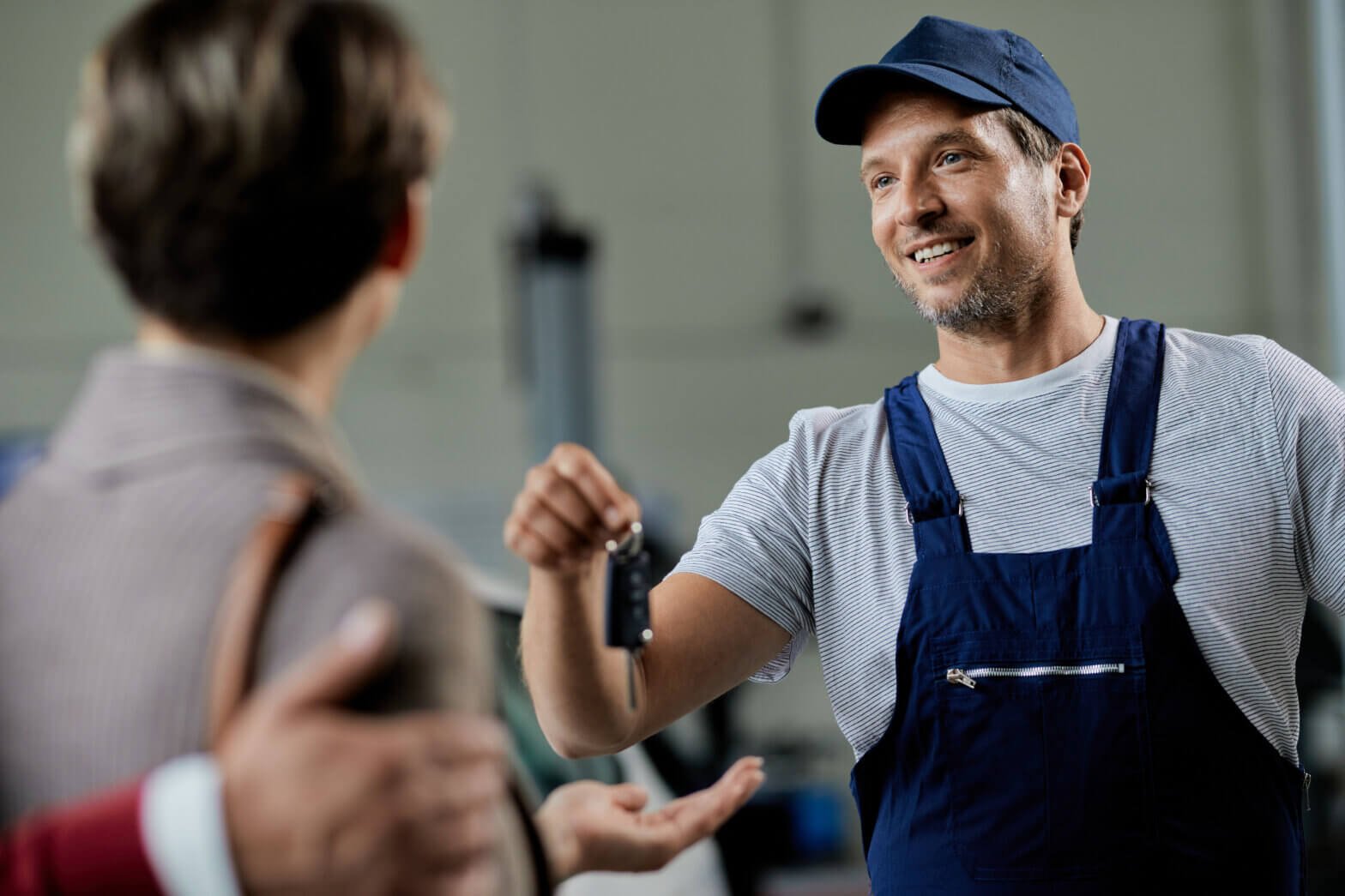 What to Do After Losing Your House Keys a locksmith giving a key to a woman