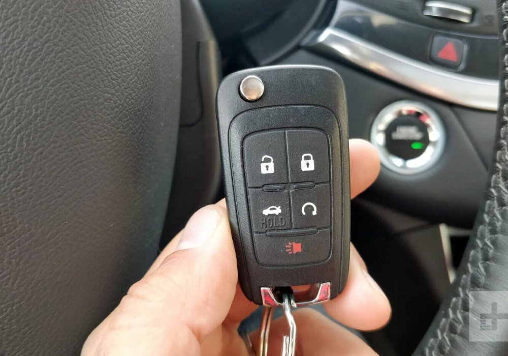 Car Key Fob Replacement and Programming Guide hand holding car key