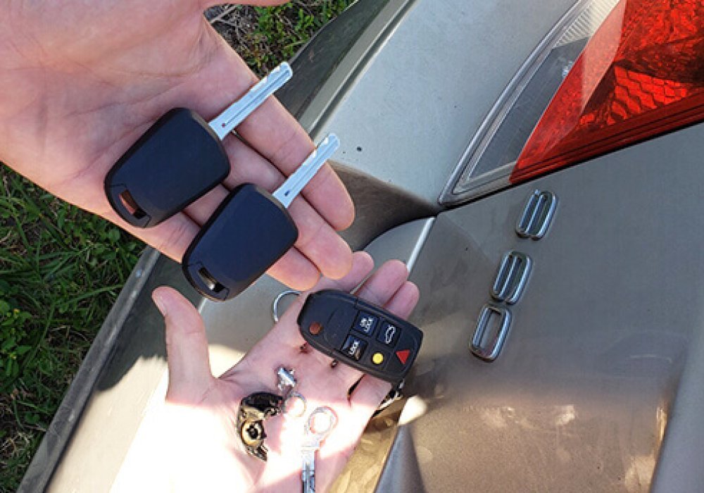 Do You Need Proof of Ownership for Car Key Replacement two hand holding car key